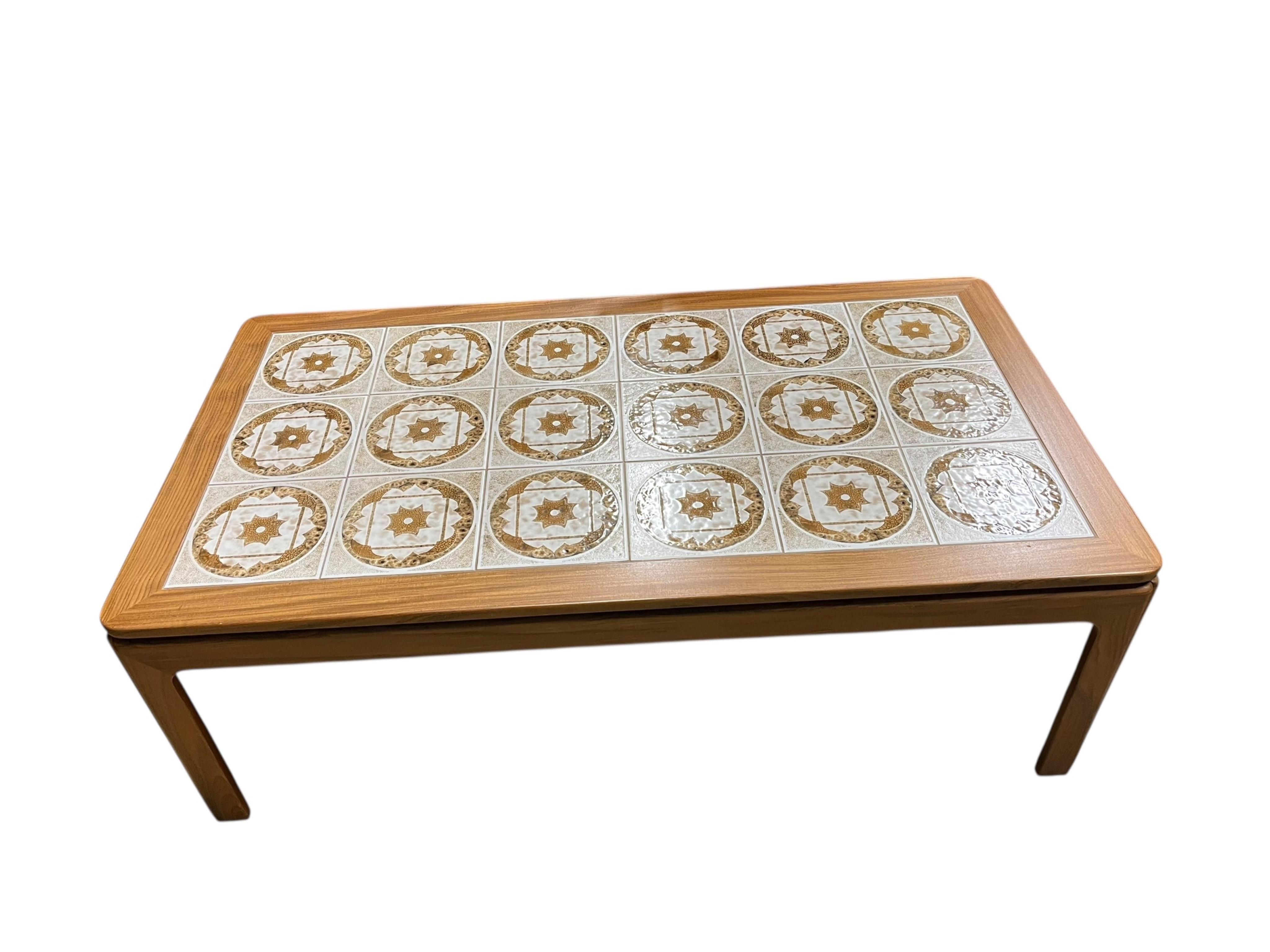 A mid century G Plan tile top teak coffee table and two matching occasional tables, larger width 134cm, depth 74cm, height 46cm